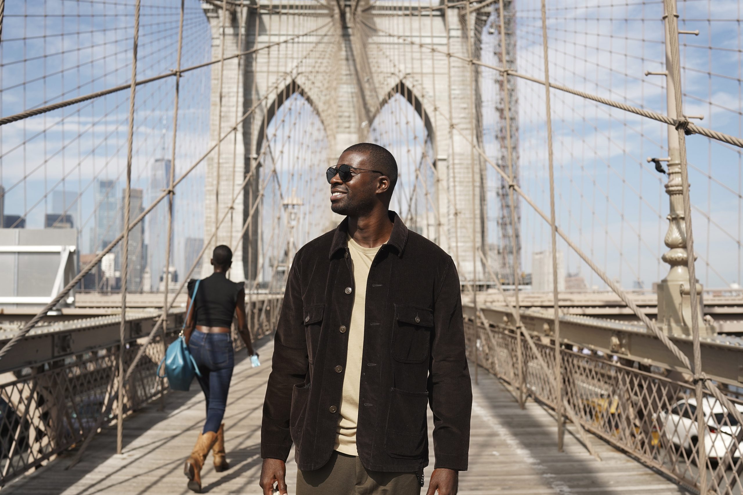 black-tourist-man-exploring-a-city-bridge